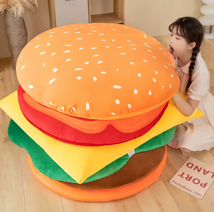 Giant 90 cm plush hamburger with a person next to it for scale